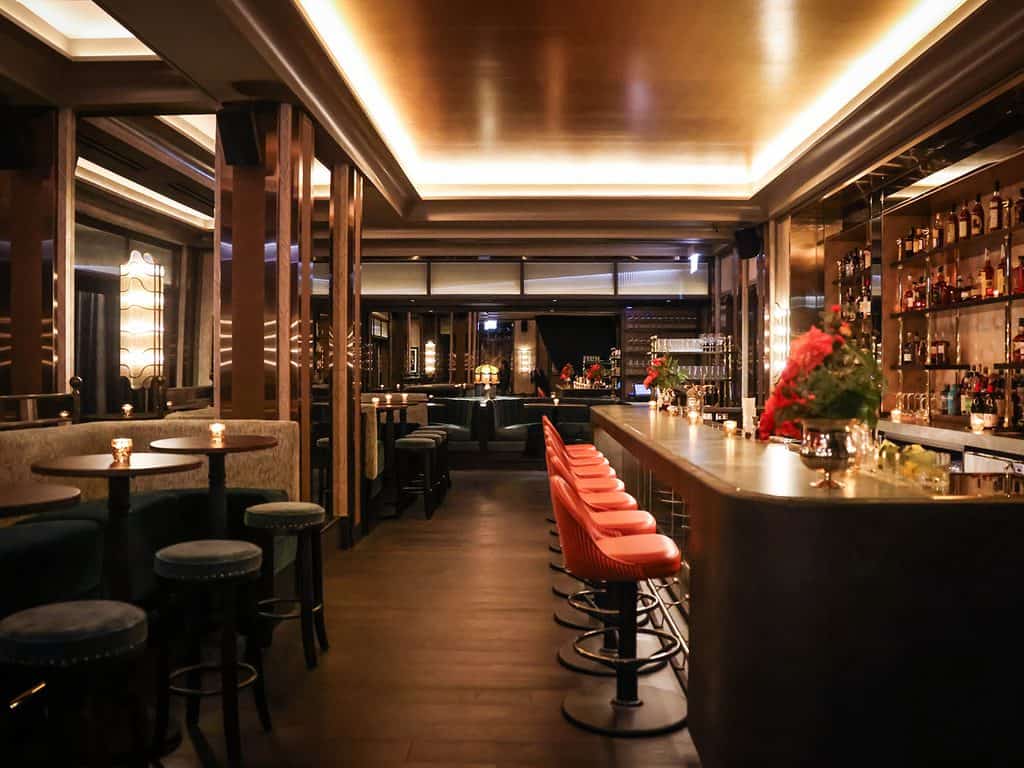 Elegant bar interior with modern design and cozy lighting at The Alston.