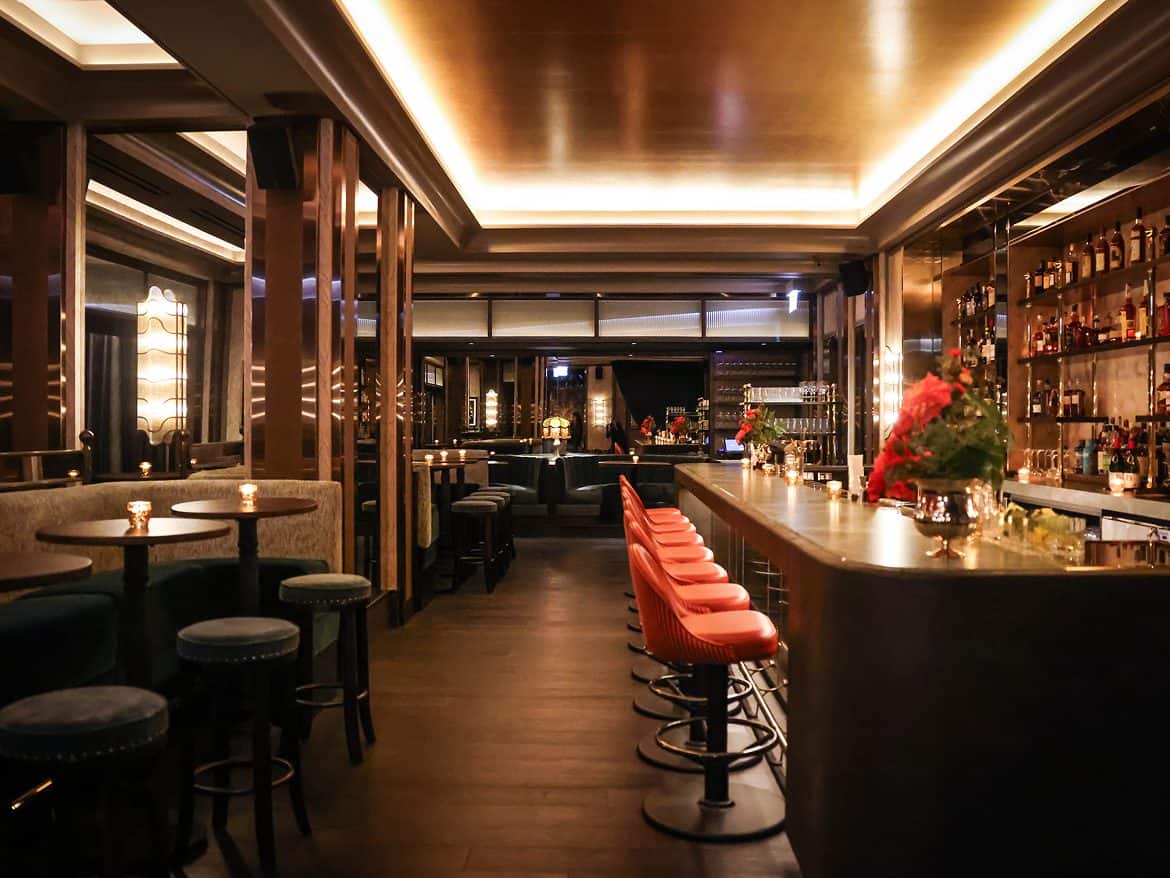 Elegant bar interior with modern design and cozy lighting at The Alston.