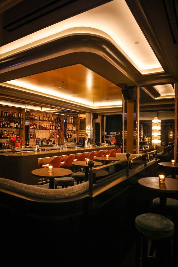 Elegant hotel bar with warm lighting and modern decor.