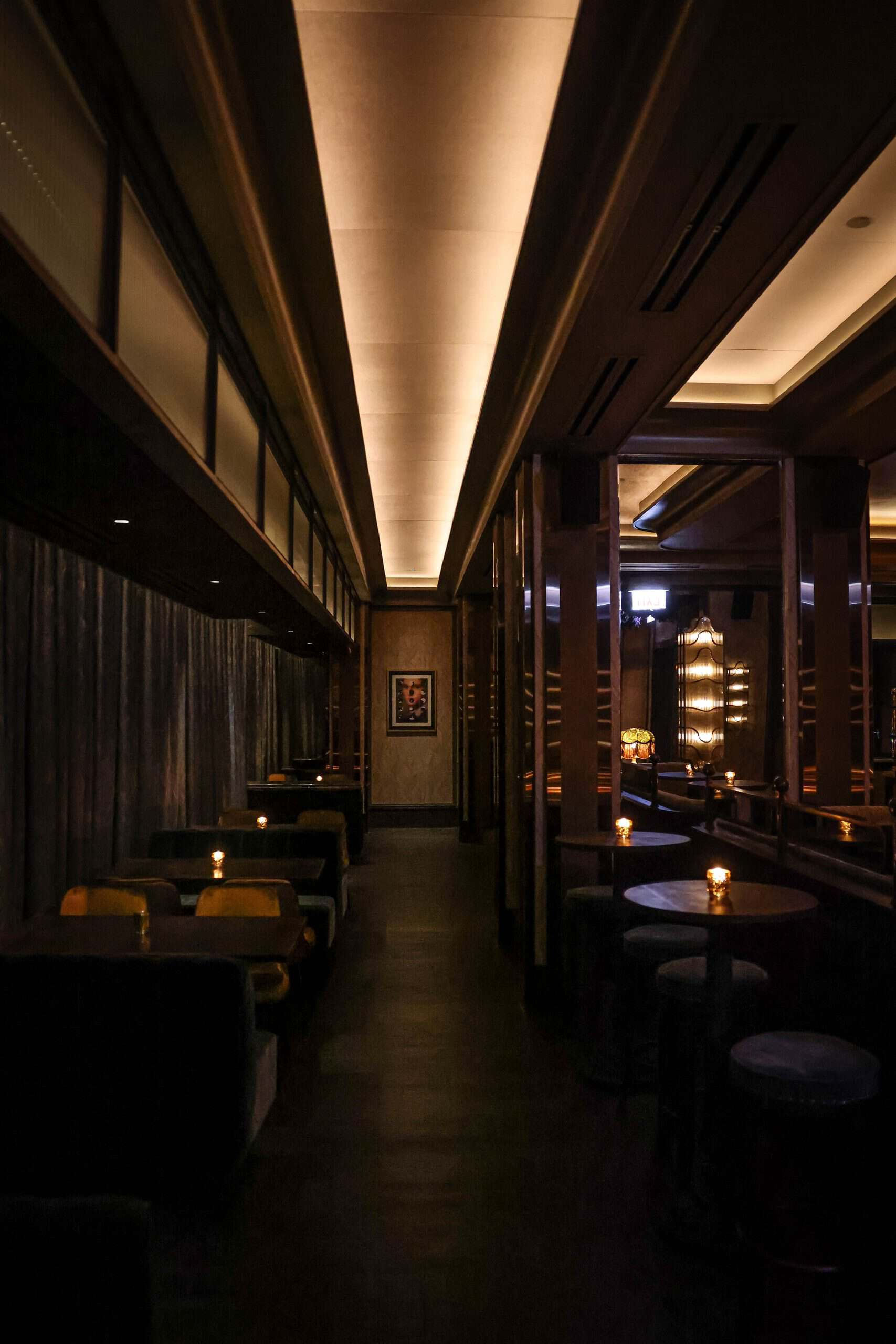 Luxurious lounge interior with dim lighting and cozy seating at The Alston.