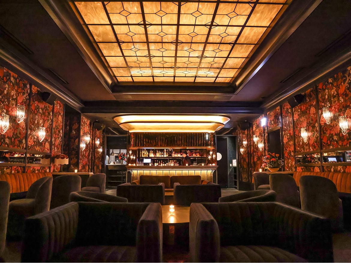 Luxurious lounge at The Alston Members Club with elegant lighting and decor.
